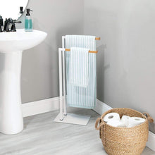Load image into Gallery viewer, Latest mdesign tall modern metal and bamboo wood towel rack holder 2 tier organizer for bathroom storage and organization next to tub or shower holds bath hand towels washcloths white natural